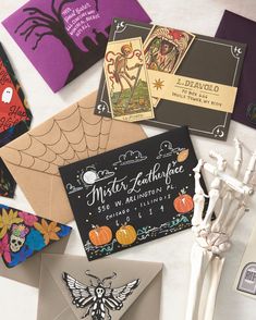 various halloween cards and skeleton bones on a table