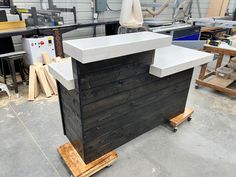 a kitchen island made out of pallets in a shop