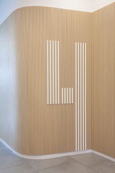 an empty room with vertical lines on the wall