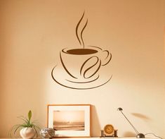 a coffee cup wall decal on the wall next to a desk with a clock