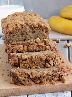 sliced loaf of banana bread sitting on top of a wooden cutting board