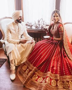 a bride and groom sitting on a couch