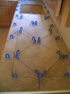 a kitchen counter with blue tape taped around the edges to make it look like hexagonal shapes