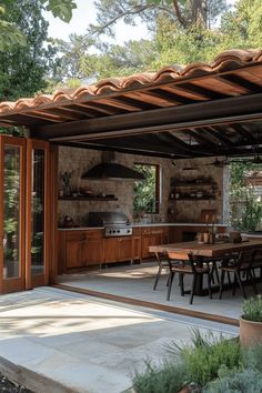 an outdoor kitchen and dining area is shown