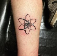 a tattoo on the leg of a person with an object in it's center