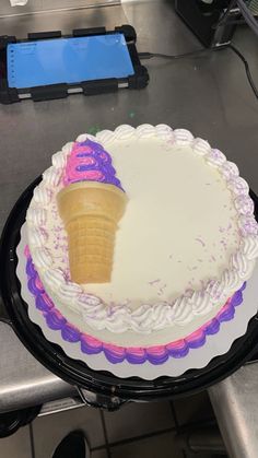 there is a cake with an ice cream cone on it