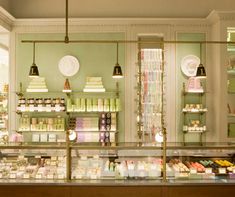 the inside of a store with lots of items on shelves and lights hanging from the ceiling