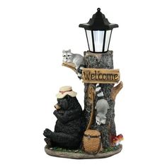 a lamp post with two bears and a welcome sign