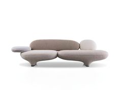 a white couch with two pillows on it's back and the seat upholstered