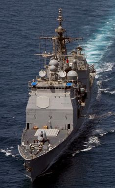 an aerial view of a navy ship in the ocean