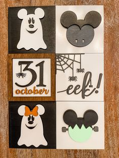 mickey mouse cut outs are displayed on a table with the numbers thirteen, eleven and fifteen