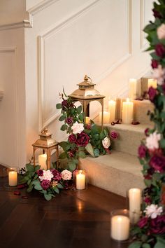 candles and flowers are on the floor next to some stairs