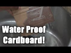 water proof cardboard in the kitchen sink with someone removing it from the faucet