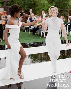 two women in white dresses dancing on a dance floor