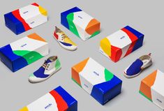 an assortment of colorful shoes and boxes on a gray surface with the same color scheme