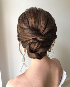 a woman with her hair in a low bun