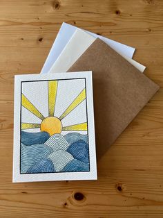 three greeting cards on top of each other with the sun in the sky above water