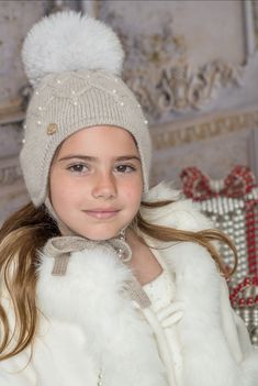 This Karenina Pearl Hat is the perfect winter accessory for kids. With a grey beige color and aviator style, it provides both warmth and style. The ear coverage and under chin ties ensure a snug fit, while the detachable pom adds a touch of charm. The addition of pearls adds a touch of elegance to this functional hat. Available in 3 sizes Unlined Imported detachable fox fur pom for easy washing super soft and comfortable for sensitive baby skin 100% cashmere Care Instructions: Remove Pom. Hand w White Double Pom Pom Hat, Baby Hat With Fur, Victorian Cape, White Beanie With Fur Pom Pom, Kids Winter Hats, Katherine's Collection, Girls Dress Outfits, Fur Pom Pom Beanie, Baby Boy Hats