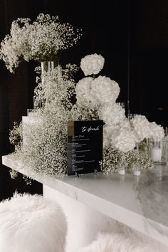 white flowers and candles sit on a table