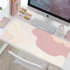 a desk with a computer monitor, keyboard and mouse