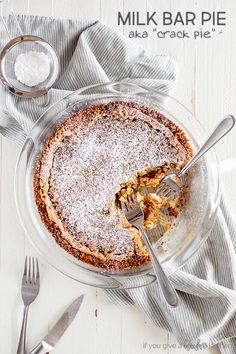 a pie with powdered sugar on top and a fork in it