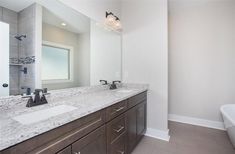 a bathroom with two sinks and a bathtub