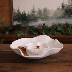 a white bowl sitting on top of a wooden table