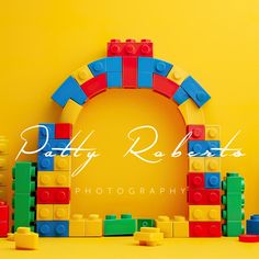 a yellow background with colorful legos on it and the words, patty roberts photography