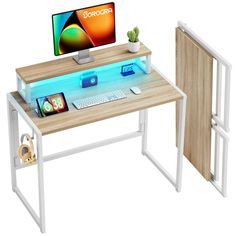 a computer desk with a monitor, keyboard and mouse sitting on it's side