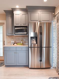 a stainless steel refrigerator and microwave in a kitchen