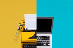 an open laptop computer sitting on top of a yellow and blue desk next to a typewriter