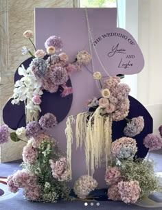 a table with flowers and a sign on it