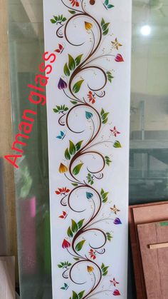 the wall is decorated with colorful flowers and vines on white paper, as well as red lettering