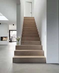 the stairs in this house are made from wood and concrete, with text above them that reads