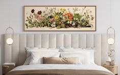 a bed with white linens and lots of flowers on the headboard is shown