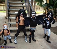 group of people with face paint posing on steps