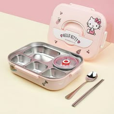 hello kitty bento lunch box with spoons and utensils next to it