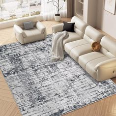 a living room with white couches and gray rug