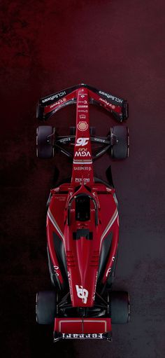 an overhead view of a racing car on a dark background