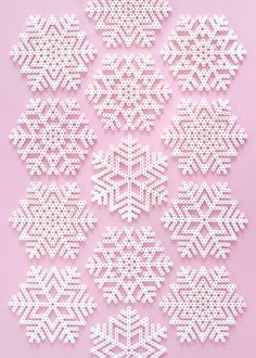 white snowflakes are arranged on a pink background with space for the wording