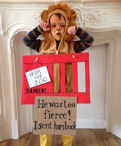 a child dressed as a lion holding a sign that reads, from the zoo he was too fierce i sent him back