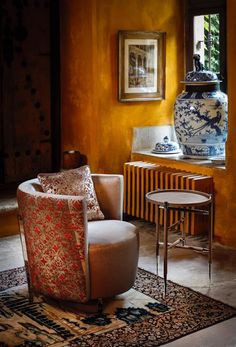 a living room filled with furniture and a large vase