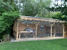 a chicken coop in the middle of a yard