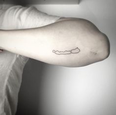 a woman's arm with a small tattoo on the left side of her arm