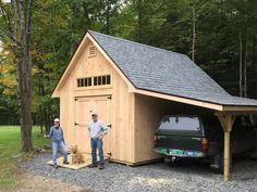 two men standing in front of a garage with a dog and truck parked next to it