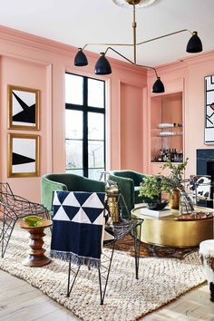 a living room filled with furniture and pink walls