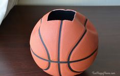 an orange basketball sitting on top of a wooden table