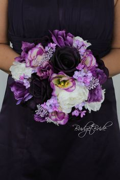 a woman in a black dress holding a purple and white bouquet