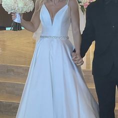 the bride and groom are walking down the stairs