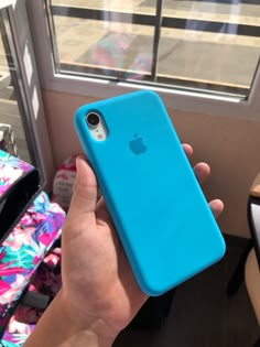 a person holding an iphone case in their hand, with the back cover partially open